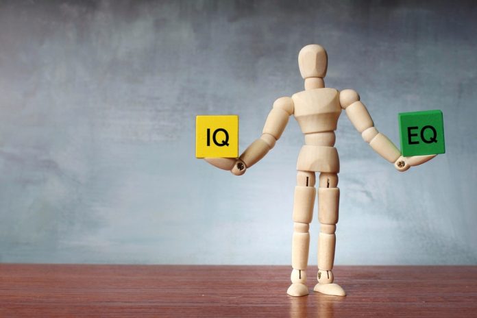 Wooden,Human,Figure,Balancing,Wooden,Cubes,With,Text,Iq,And Emotional Intelligence