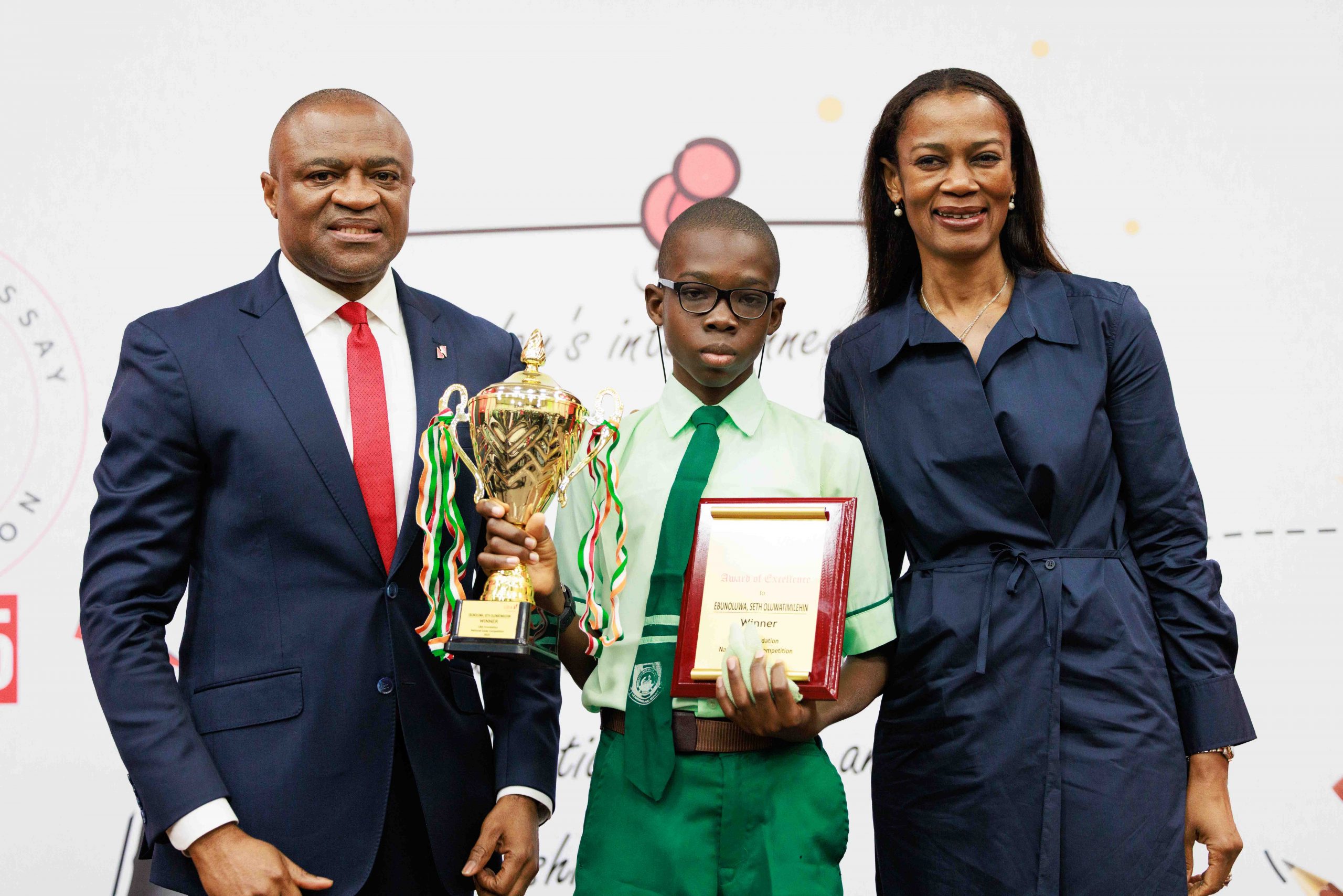 Group Managing Director/CEO, United Bank for Africa(UBA), Oliver Alawuba; Winner, 2025 UBA Foundation National Essay Competition (NEC) & Student of Igando Community Senior High School, Igando, Lagos, Ebunoluwa Seth Oluwatimelehin; and Managing Director/CEO, UBA Foundation, Bola Atta, during the grand finale of the 2025 UBA Foundation National Essay Competition for Senior School Students in Nigeria held at UBA House, Lagos, on Tuesday.