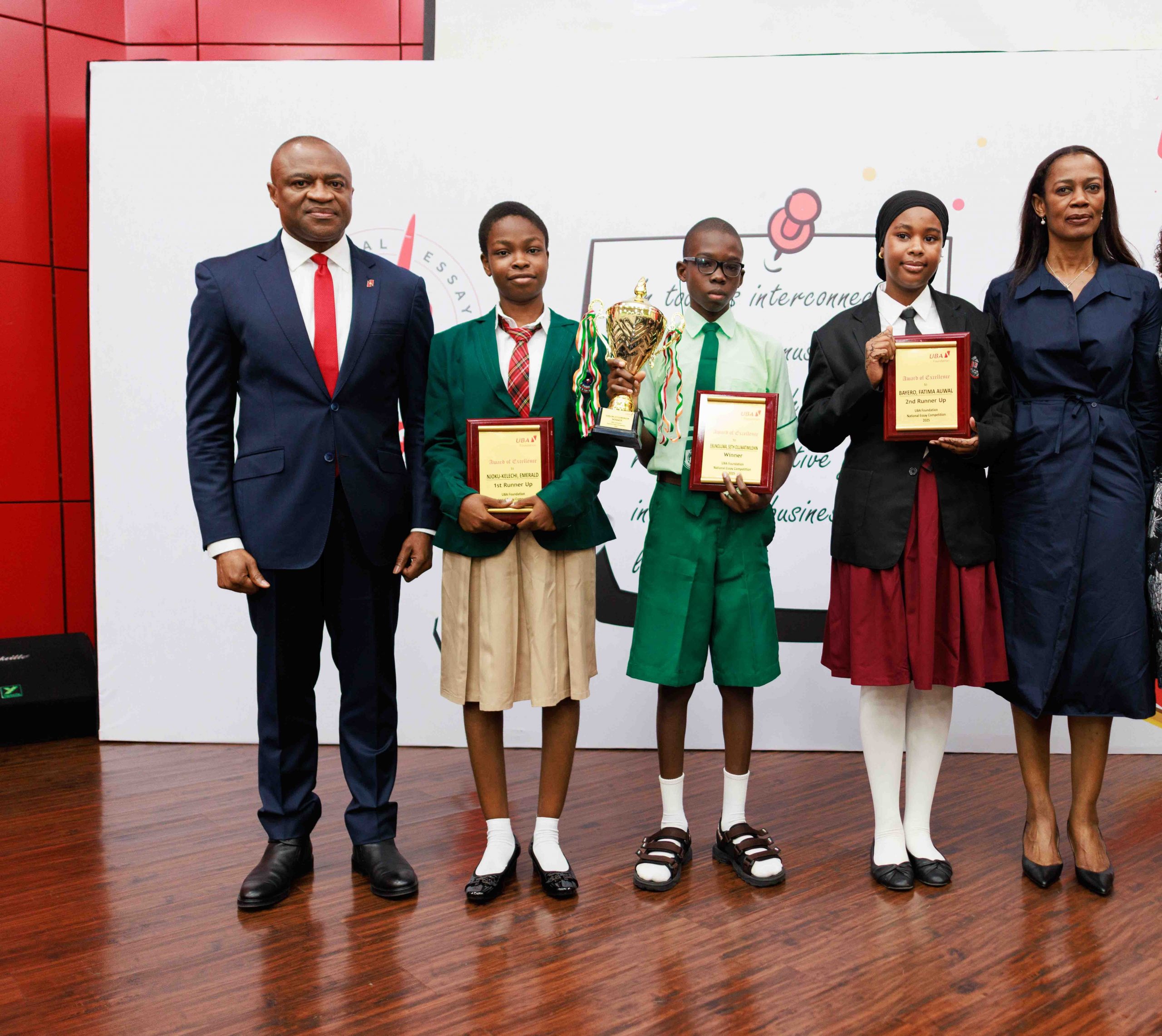 Group Managing Director/CEO, United Bank for Africa (UBA), Oliver Alawuba; 1st Runner up, 2025 UBA Foundation National Essay Competition and Student of Christian International High School, Owerri, Emerald Njokwu Kelechi; Winner, and student of Igando Community Senior High School, Igando, Lagos, Ebunoluwa Seth Oluwatimelehin; 2nd Runner up, & student of Cornerstone Montessori Schools, Gudu Abuja, Bayero Fatima Auwaland Managing Director, UBA Foundation, Bola Atta, during the grand finale of the 2025 UBA Foundation Essay Competition for Senior School Students in Nigeria held at UBA House, Lagos, on Tuesday.