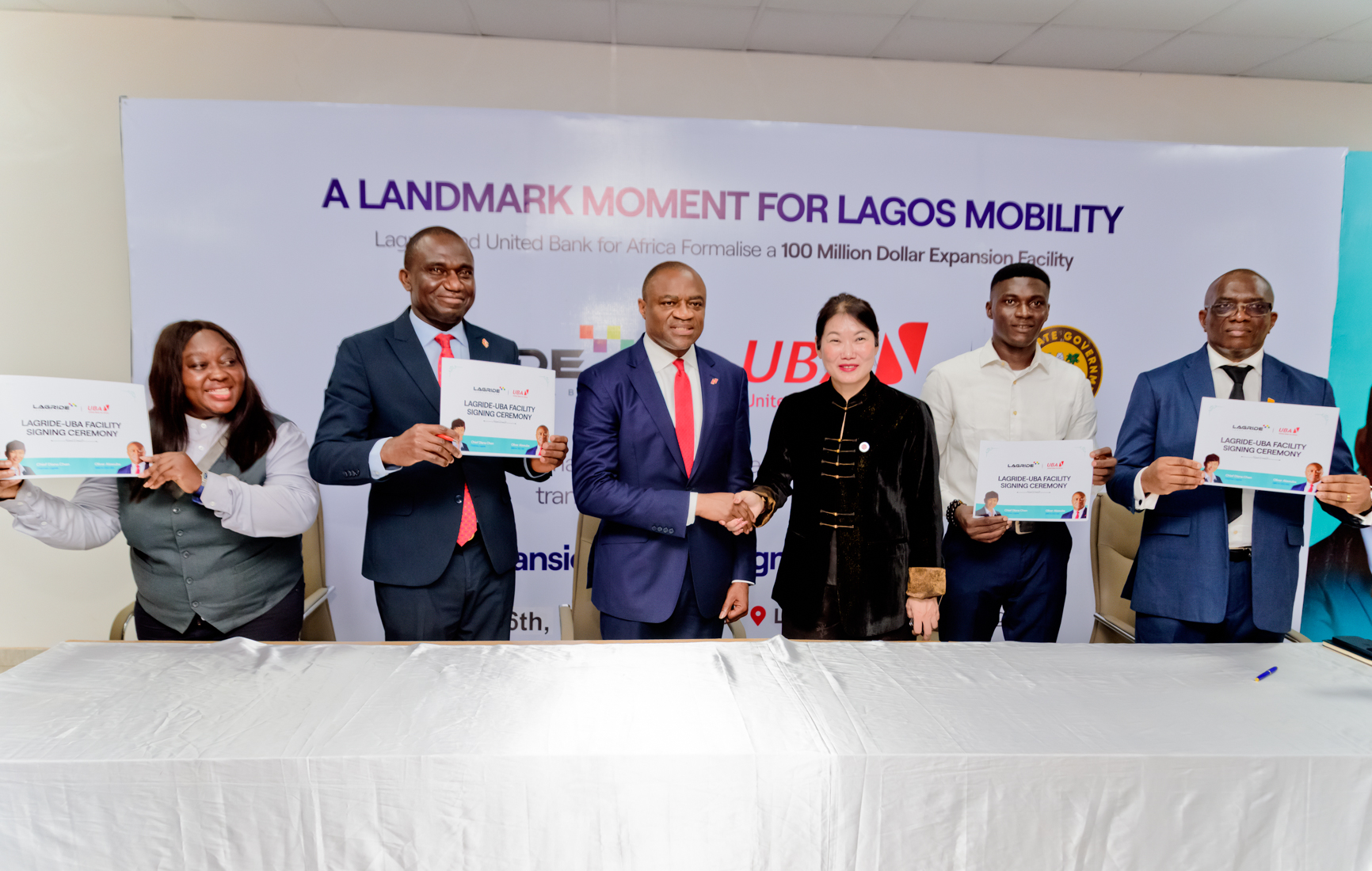 l-r: Group Managing Director/CEO, United Bank for Africa(UBA) and Chairman, LagRide, Chief Diana Chen, flagged by LagRide drivers, at the signing ceremony and launching of $100 Million "Drive to Own" Vehicle Financing Scheme, strengthening smart mobility, driver asset ownership of over 3,500 cars, financed by UBA, in partnership with Lagos State Government and LagRide, held in Lagos on Tuesday.