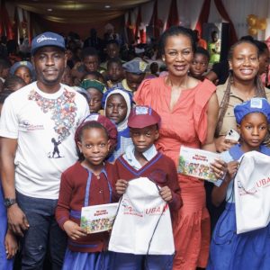 L–R: Senior Programmes Manager, Slum2School Africa, Adekunle Idowu; Managing Director, UBA Foundation, Bola Atta; and Segment Executive, Children and Youth Banking, UBA, Ozioma Obi, with pupils at the financial literacy workshop convened by UBA Foundation and Slum2School Africa, where the children received the UBA Money Explorers Book, in Lagos, recently